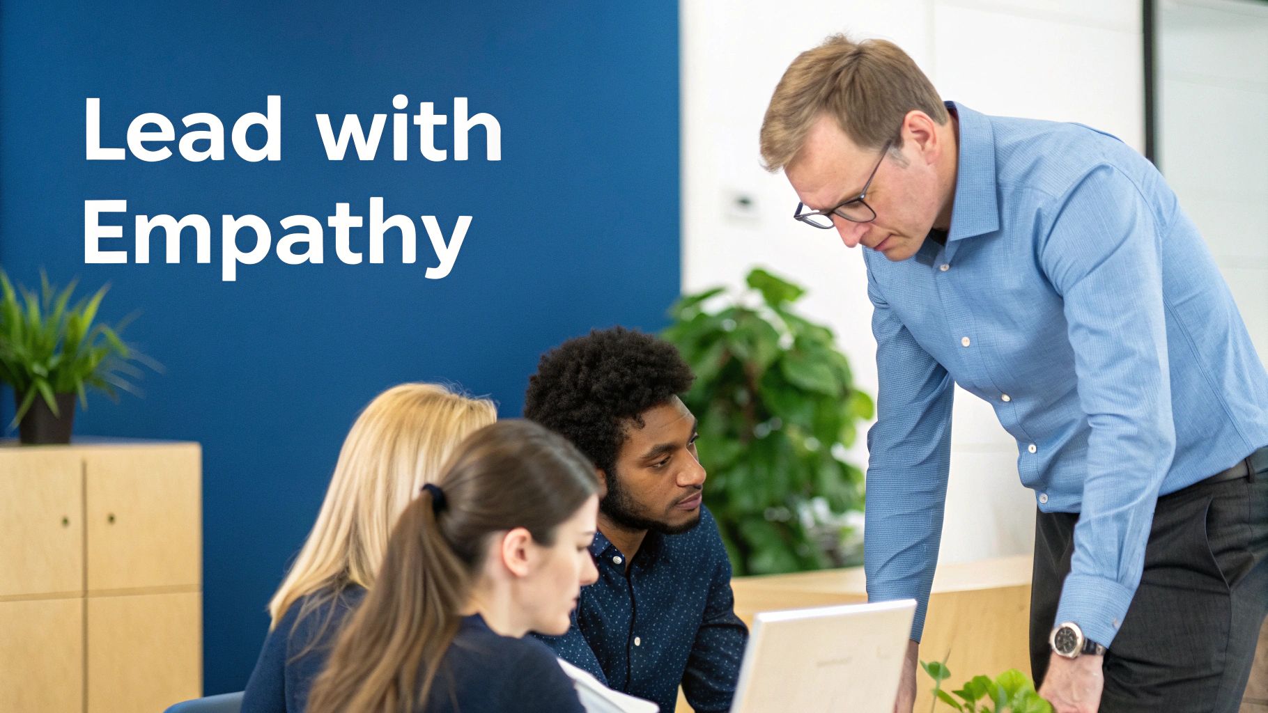 Manager leading team meeting with empathy, collaborating with diverse employees at office desk