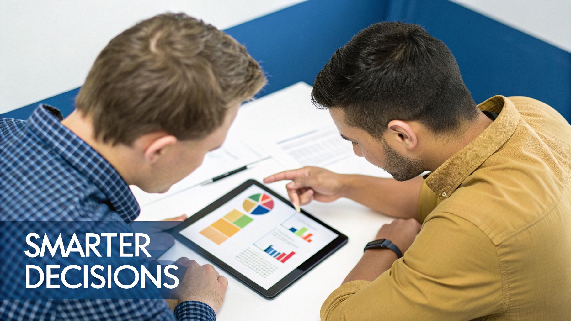 A person at a desk using a calculator and laptop to make financial decisions, reflecting the strategic use of break-even analysis.